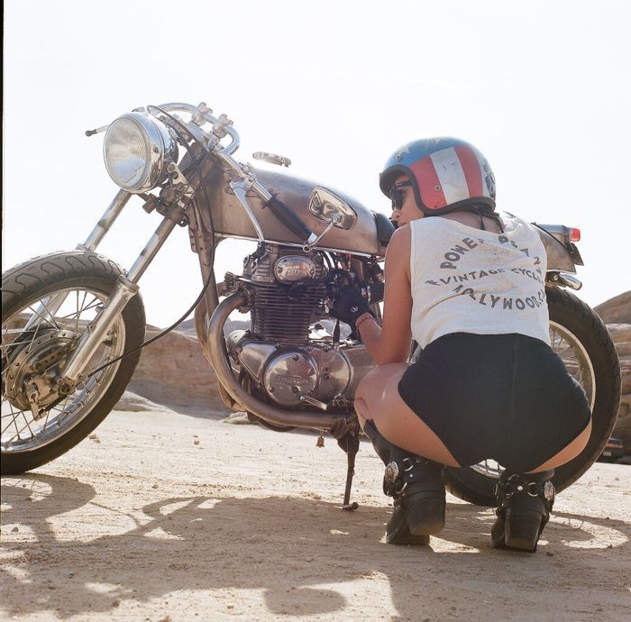 A playful frame from Girls on a motorcycle — online in Joao Pesoa